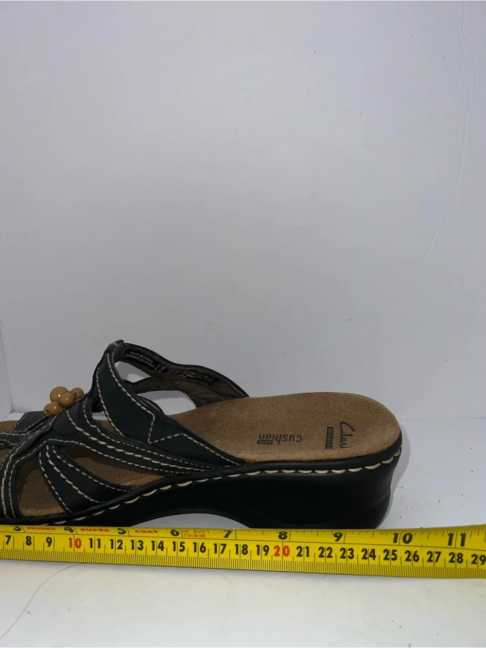 Clarks Women’s Black Leather Slip-On Sandals with Flower Accent